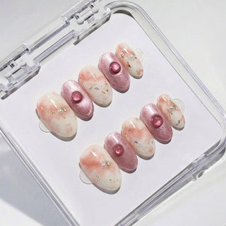 EyeCandys Raspberry Ripple press on nails featuring peach and cream marble swirl, rose pink cat eye shimmer, and raspberry glitter dome bead accents.