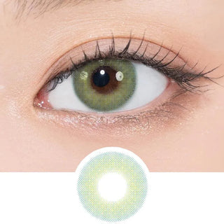 A close-up of a green eye wearing N's Collection Saba Teishoku Green (10pk) coloured contacts with natural makeup. Below the eye is a magnified view of the green and yellow lens pattern by N's Collection.