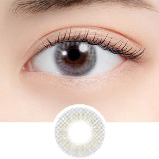 A close-up of a person's eye wearing N's Collection Tama Konnyaku Grey (10pk) contacts, with a circular inset below showing the lens design featuring a grey ring pattern.