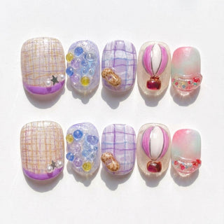 The Up Up & Away Press-On Nails by EyeCandys feature ten handmade, reusable nails with playful plaid patterns, colorful beads, balloon and cloud motifs, and pastel gradients for a unique whimsical style.