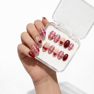 Hand wearing EyeCandys Very Cherry press on nails featuring fuchsia and cherry red tones with 3D cherry nail art and gold accents.