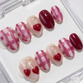 Round press on nails Very Cherry with bold cherry red and fuchsia colors, 3D cherry motifs, and sleek gold detailing for a fun summer manicure.