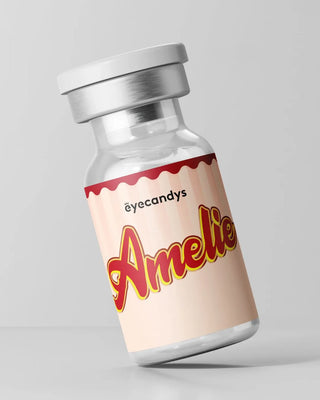 A small glass vial with a silver cap features a cream and red label reading "Amelie Earl Grey" in bold letters, ideal for cosmetic contacts. The brand name "EyeCandys" is printed above, set against a plain light gray background.