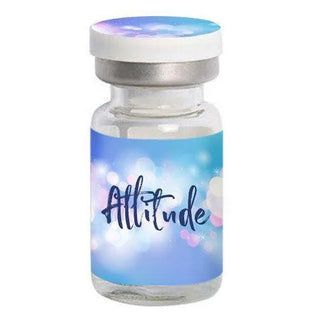 A small glass vial with a blue and white label reading "EyeCandys Attitude Glitter Brown" in cursive font, designed for natural colored contacts. The vial has a blue and white cap and a soft, blurred background. Brand: EyeCandys.