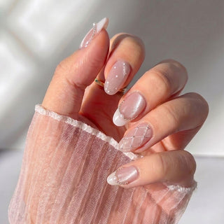 Stylish hand wearing EyeCandys Ballet Slippers press on nails featuring quilted texture nails and glossy ballet pink finish.