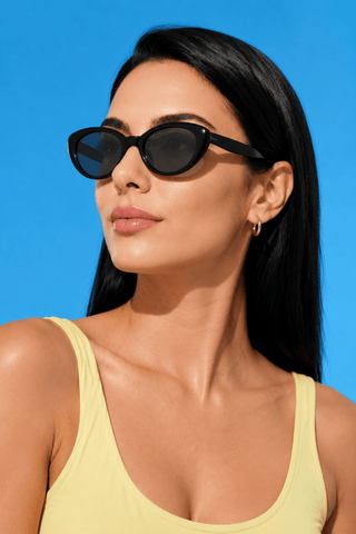EyeCandys Bardot Cat Eye Black sunglasses model shot featuring oversized black cat-eye sunglasses with UV protection, trendy women's fashion eyewear, designer-inspired shades for everyday wear, summer outfits, travel, luxury fashion, and street style.
