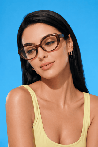 EyeCandys Bardot Cat Eye Wine clear frame glasses model shot featuring transparent wine red cat-eye frames with non-prescription clear lenses, trendy women's fashion eyewear for everyday wear, office style, blue light fashion frames, and chic minimalist looks.