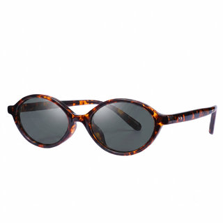 Retro-inspired eyewear, the EyeCandys Cassian Round Oval glasses feature dark lenses and a glossy brown tortoiseshell frame, set against a plain white background.