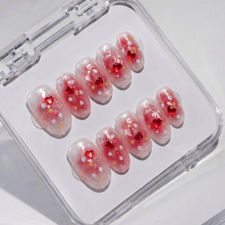 EyeCandys Catching Feelings press on nails featuring sheer peach jelly nails with red heart sequins, white confetti dots, and yellow star flecks.