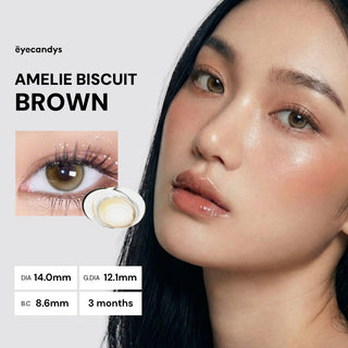 Close-up of a woman wearing EyeCandys Amelie Biscuit Brown contact lenses, enhancing brown eyes. Features lens close-up, DIA 14.0mm, G.DIA 12.1mm, BC 8.6mm specs, and offers a 3-month usage duration.