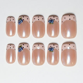 Eyecandys Berry French press-on nails featuring a warm pearlescent nude base, pastel pink French tips, hand-painted blueberry accents, and a short square shape.