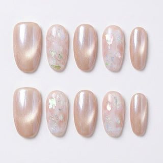 Eyecandys Champagne Toast press-on nails featuring a warm peach champagne cat-eye finish, pearlescent shimmer, iridescent accent nails, and a short oval shape.