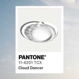 Macro shot of EyeCandys Desire Innocent White Grey prescription colored contact lens - Cloud-Dancer 2026 Color of the Year, detailed lens design, vibrant natural grey color, comfortable daily wear, trending cosmetic lenses