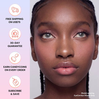 A woman with braided hair wears EyeCandys Shade Grey contact lenses and pink makeup. Next to her are icons and text: free shipping on US$75, 30-day guarantee, earn CandyCoins on every order, subscribe & save.