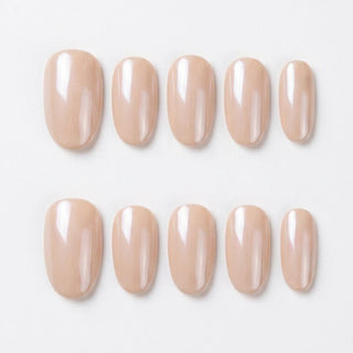 Close-up of Eyecandys Silk Slip reusable press-on nails showcasing a pearlescent champagne pink chrome finish with a glossy glazed shine.