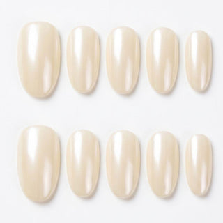 Eyecandys Soft Serve press-on nails featuring a pearl white chrome finish, creamy glazed shine, and a short oval shape.