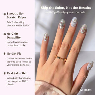 Stylish hand wearing EyeCandys Fleur de Slay press on nails featuring coquette blue nails with chrome heart and diamante flowers.