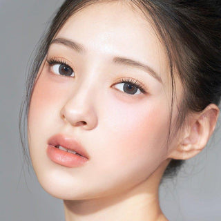 Asian model demonstrating a K-idol-inspired look with 1-Day Grey coloured contact lenses, highlighting the instant brightening and enlarging effect of the circle contact lenses over dark irises.