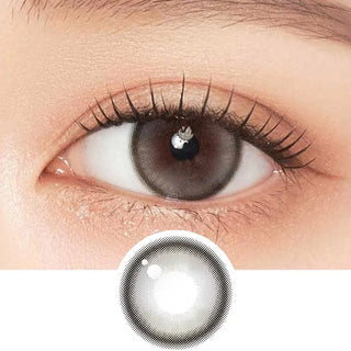 A close-up of an eye wearing Gemhour Demeter 1-Day 13.0 Pebble Grey contact lenses by Gemhour, with detailed design inset below. Features long lashes and natural makeup—ideal daily disposable color contacts in a 10-pack.