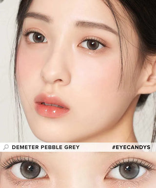 A close-up of a woman with fair skin, glossy lips, and straight dark hair wearing Gemhour Demeter 1-Day 13.0 Pebble Grey (10pk) color contacts. Below, her eyes show the Gemhour Pebble Grey lenses in detailed view.