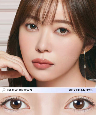 A woman with straight brown hair and natural makeup wears Topards 1-Day Glow Brown (10pk) contact lenses. A close-up of her eyes with the lenses appears. Text reads "Glow Brown" and "#EYECANDYS." Brand: Topards.