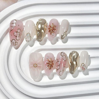 Short oval press on nails EyeCandys Hanami with 3D floral texture, chrome silver wave nail, pearl accent, and delicate silver detailing.