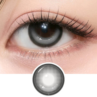 Close-up of eye with long lashes wearing i-Girl One Pick Dear One Grey contact lens from EyeCandys, showing cool grey iris color and detailed lens design