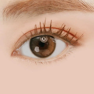 Macro shot of an eye wearing the i-Sha Oriana Shade Grey prescription colour contact lens, showing the multi-colored detail and natural effect on dark brown eyes.