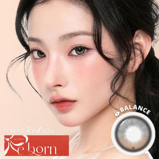 Model wearing i-SHA Reborn Red 1-Day Creamy Brown (10pk) colored contact lenses from EyeCandys, showcasing a warm chocolate brown ribbon-lace design with subtle red undertones for a soft, cozy, and naturally defined eye look.