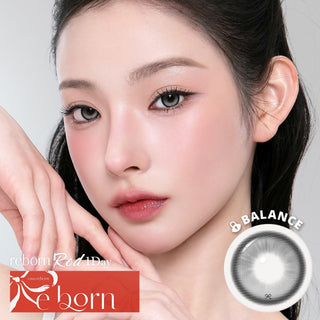 Model wearing EyeCandys i-SHA Reborn Red 1-Day Milky Gray (10pk) colored contact lenses featuring a cool, clouded gray ribbon-lace design with a frosted watercolor finish. Silicone hydrogel daily lenses with fixed-axis weighted technology for a misty, editorial-inspired eye look and comfortable all-day wear.