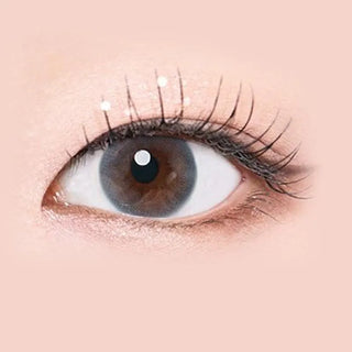 Macro shot of an eye wearing the i-Sha Serenity Grey prescription colour contact lens, showing the multi-colored detail and natural effect on dark brown eyes.
