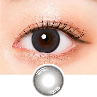 Macro shot of an eye wearing the i-Sha Oriana Mune 1-Day Grey (10pk) prescription colour contact lens, showing the multi-colored detail and natural effect on dark brown eyes, with clean eye makeup. At the bottom is the pattern of the colored lens design, showing the dotted detail and pigmentation.