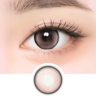 i-Girl IG Pink Beige color contact lens on top of a dark eye paired with subtle eye makeup and curled wispy eyelashes, above the contact lens design.
