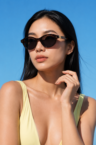 Model wearing EyeCandys Loretta Round Oval tortoiseshell full-frame sunglasses. Lightweight TR oval frames with a vintage-inspired design, medium fit, flattering diamond and heart face shapes.