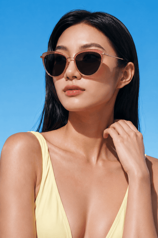 Model wearing EyeCandys Shelly Cat-Eye sunglasses. Medium-fit full-frame cat-eye sunglasses with a sleek, modern silhouette designed to flatter square, triangle, round, oval, and oblong face shapes.
