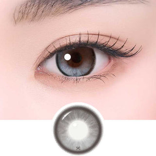 i-Sha Reborn Moon Stone color contact lens on top of a dark eye paired with subtle eye makeup and curled wispy eyelashes, above the contact lens design.
