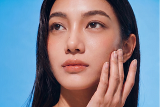 Close-up of model with natural eye color, no contact lenses, and bare nails, clean beauty aesthetic and minimal makeup look.