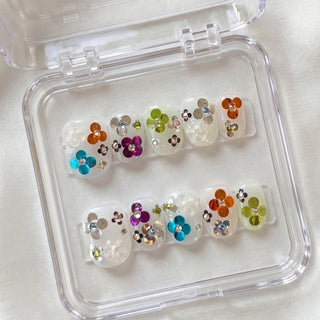 Short round press on nails EyeCandys Petal Rave with jelly base, multicolour confetti sequins, raised 3D flowers, and crystal accents.
