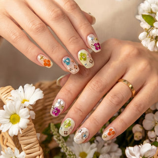 Hand wearing EyeCandys Petal Rave press on nails featuring jelly nails with multicolour sequins, 3D floral motifs, and crystal accents.