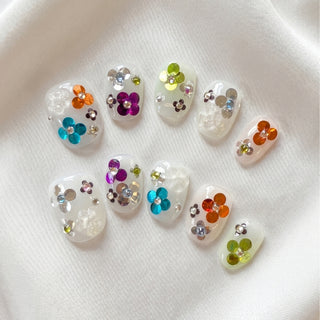 EyeCandys Petal Rave press on nails featuring sheer jelly nails with embedded multicolour sequins, 3D floral gel motifs, and crystal centres.