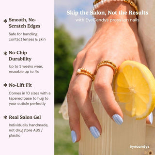 Close up hand showcasing EyeCandys Pinstripes press on nails with clean white vertical stripes on glossy blue nails.
