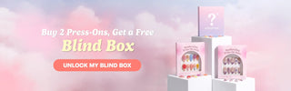 Handcrafted press-on nail gift boxes displayed on white podiums with a mystery blind box against a pastel cloud background.