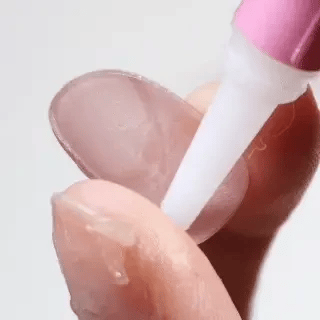 Application of glue to EyeCandys press-on nails showing step-by-step nail glue placement for secure adhesion and long-lasting manicure wear