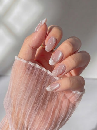 Wearing EyeCandys Ballet Slippers Press-On Nails, soft nude ballet pink with glossy satin finish, quilted texture, pearl outlines, and subtle French tips in an oval shape