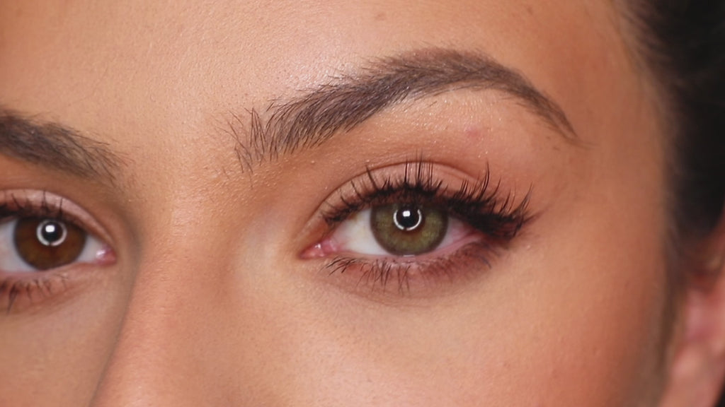 Video of model sporting Isla Emerald Green contact lens on one eye and the other without one, paired with natural eyeshadow..