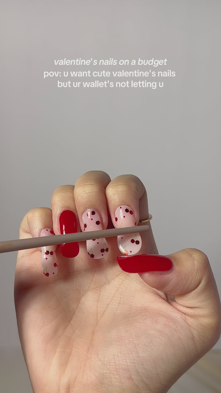  Video showing step-by-step application of EyeCandys Petite Cherry Gel Nail Stickers in a red and cherry dot design. Watch how to achieve a salon-quality manicure at home in minutes using semi-cured gel stickers that last up to 2 weeks with a glossy finish.