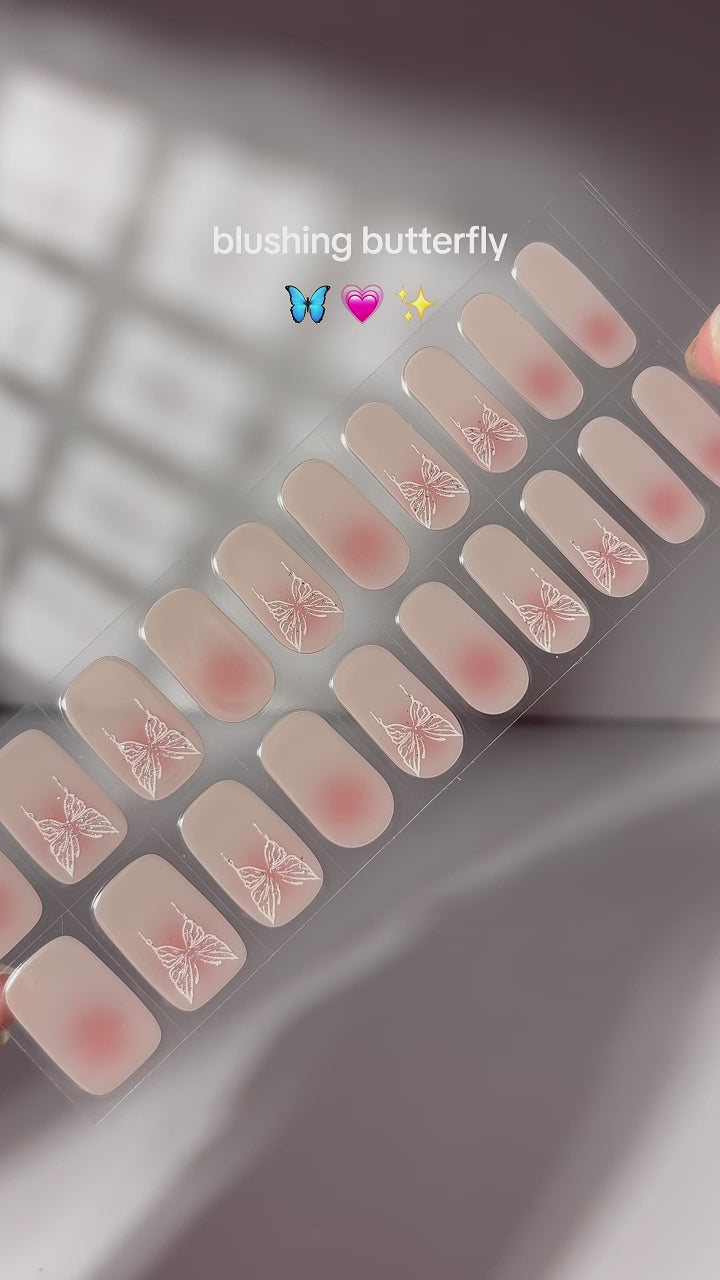  Video demonstrating the application of EyeCandys Flutter Gel Nail Stickers. Watch how to achieve effortless, long-lasting spring nails with a delicate fluttering design. The 7-free, allergy-friendly formula cures in sunlight, lasting 2-3 weeks without the need for a UV lamp.