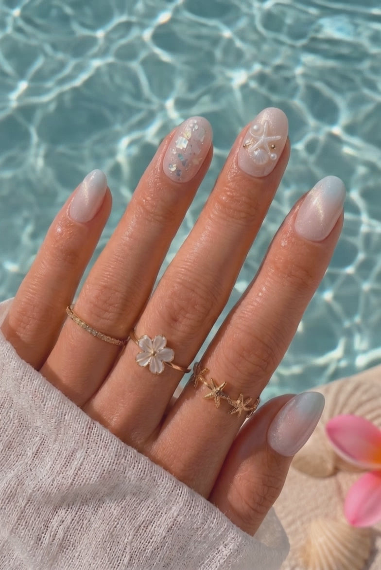Wearing EyeCandys Pearl Jam Press-On Nails, pearly peach base melting into cool mint at the tips with cat-eye shimmer in an oval shape