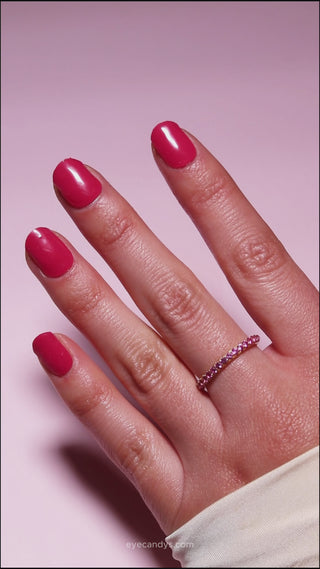 Hand with EyeCandys Red My Mink Gel nail stickers applied, showcasing a bold red color. Ideal for classic, vibrant manicures, offering long-lasting wear, easy application, and a high-shine, salon-quality gel finish for stunning, polished nails.