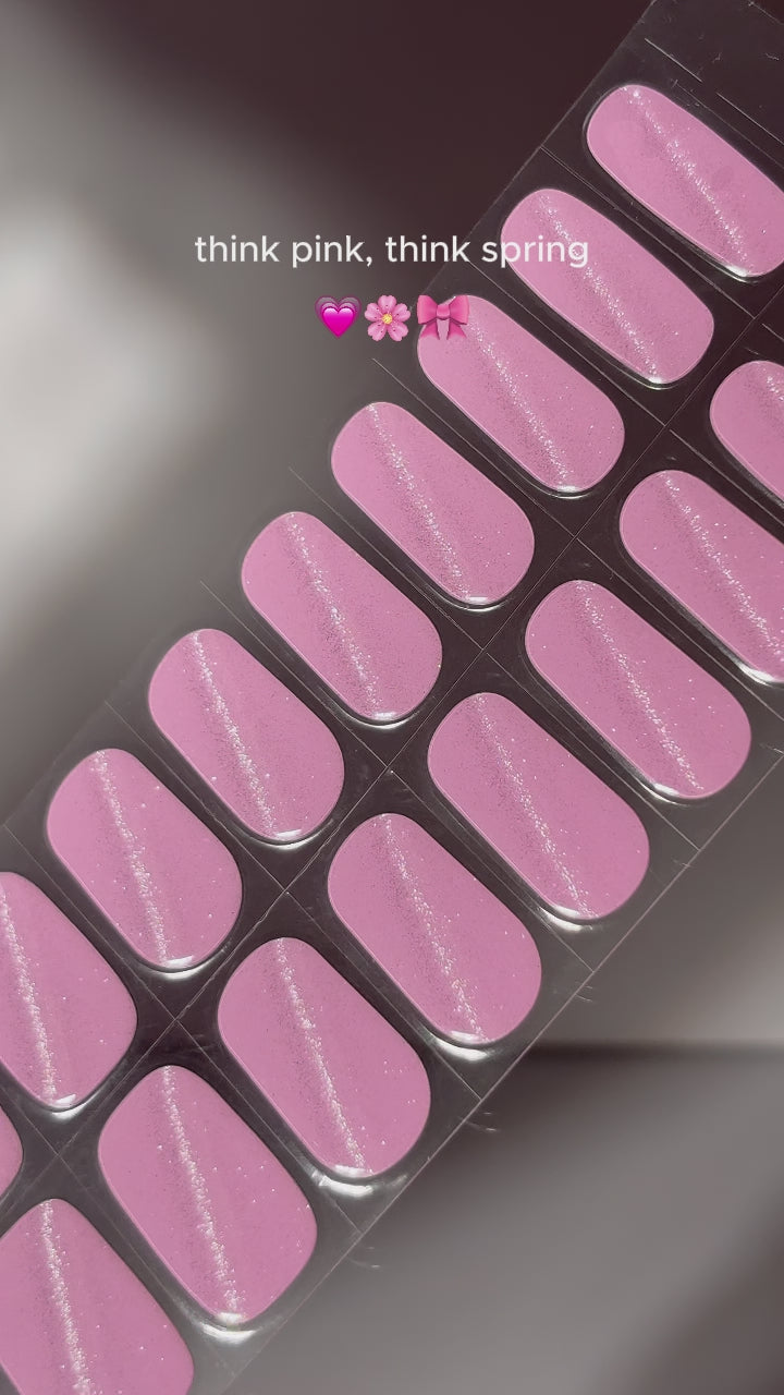  Video showing the step-by-step application of EyeCandys Pilates Princess Gel Nail Stickers in pink with glitter. Watch how easy it is to apply these 7-free, allergy-friendly stickers for salon-quality nails that last 2-3 weeks. Cures in sunlight without a UV lamp, perfect for trendy, sparkling spring nails.